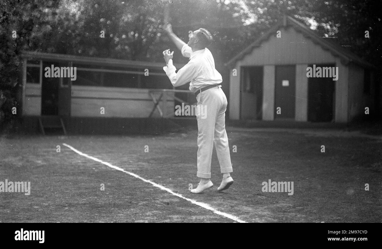 Tennis player serving at Moorfield Tennis Club in Stockport - an adventurpous and successful 'action' shot of the day Stock Photo