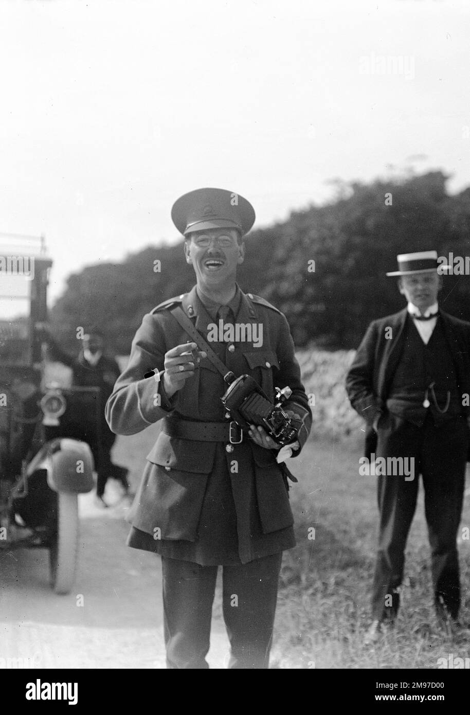 Soldier with camera, location unknown but believed to be in the UK. A delighfully spontaneous shot with short depth of field giving maximum prominence to the main subject, obviously a fellow camera enthusiast! Stock Photo