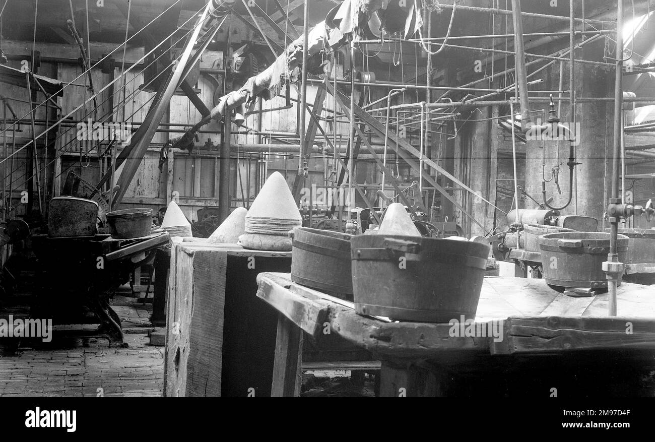 Plank shop at Battersby's hatworks showing formed felt 'cones', te basis for a fur felt hat. Note the huge amount of pipework, and the exposed belt drives to the machinery. Stock Photo