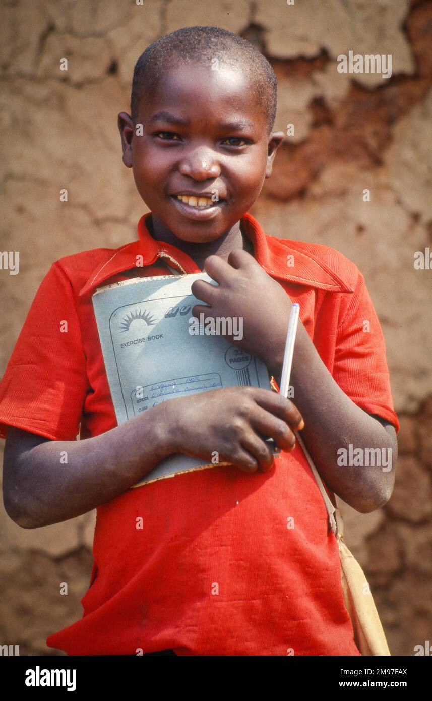 Uganda, Mbarara; boy with exercise book on his way to primary school. Stock Photo