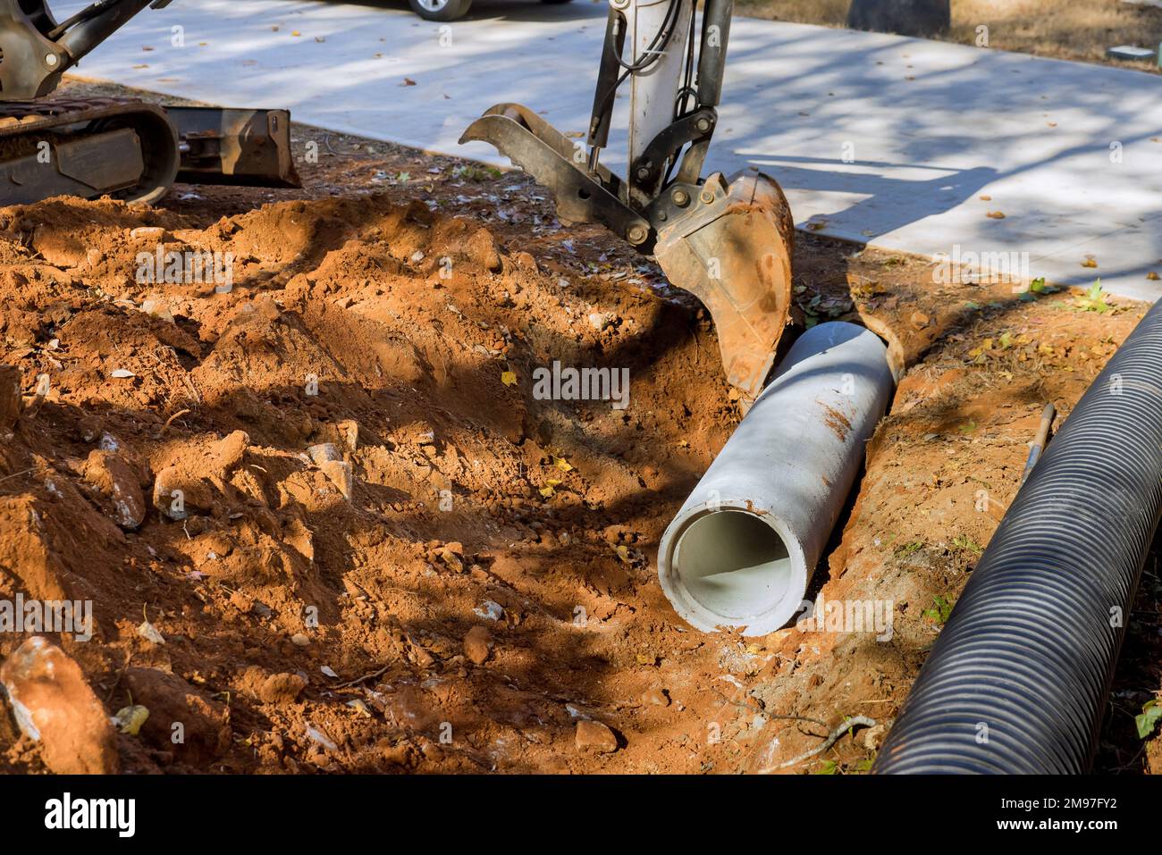 An employee who operates tractor lift to drive sewage concrete pipes