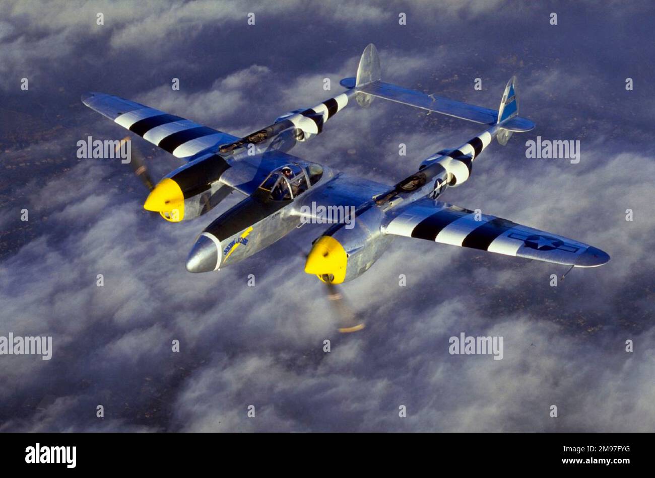 Lockheed P-38J Lightning -in D-Day stripes to help distinguish Allied from enemy aircraft in the heat of battle. Stock Photo