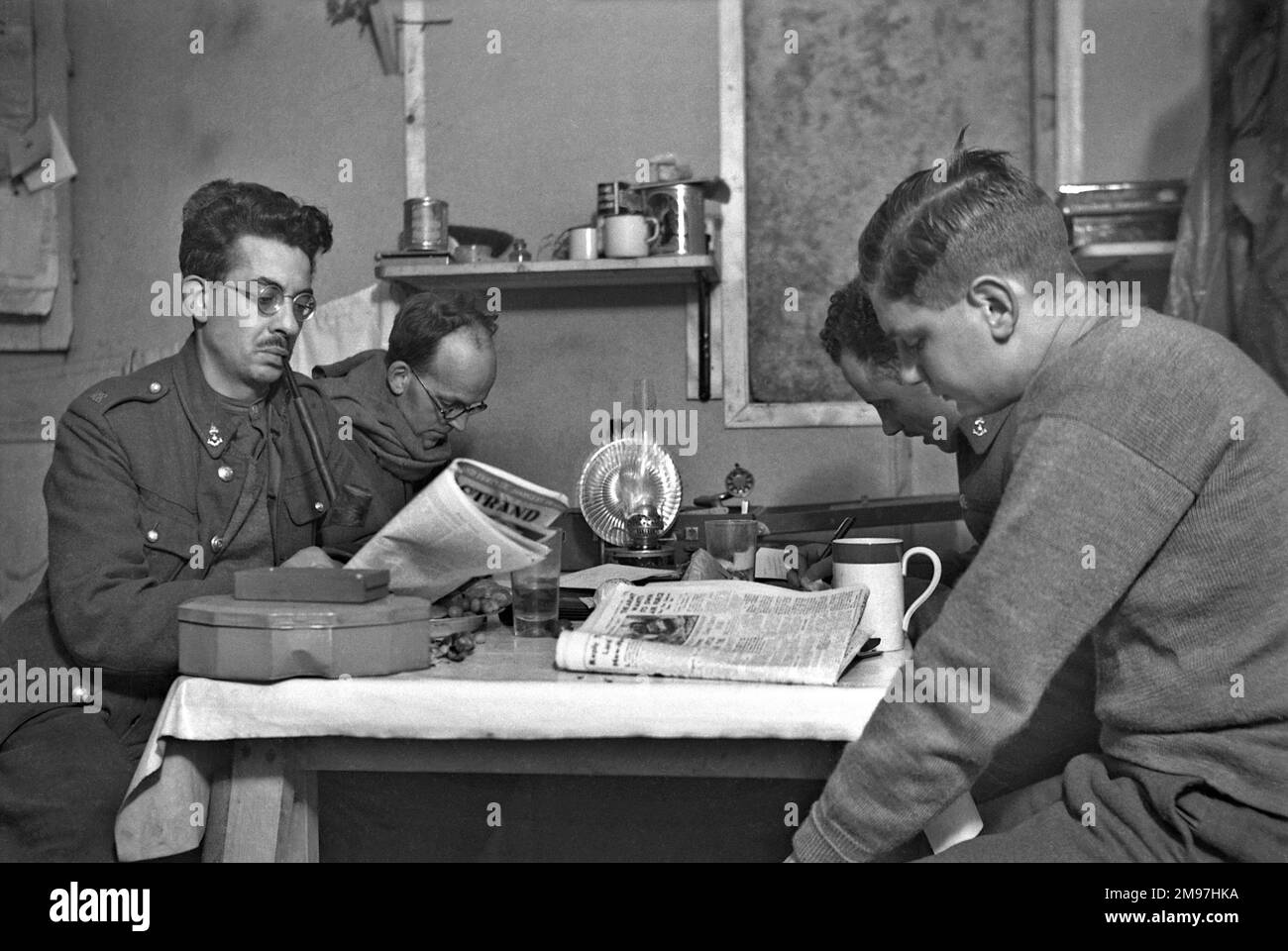 Four soldiers relaxing in an army hut. Stock Photo