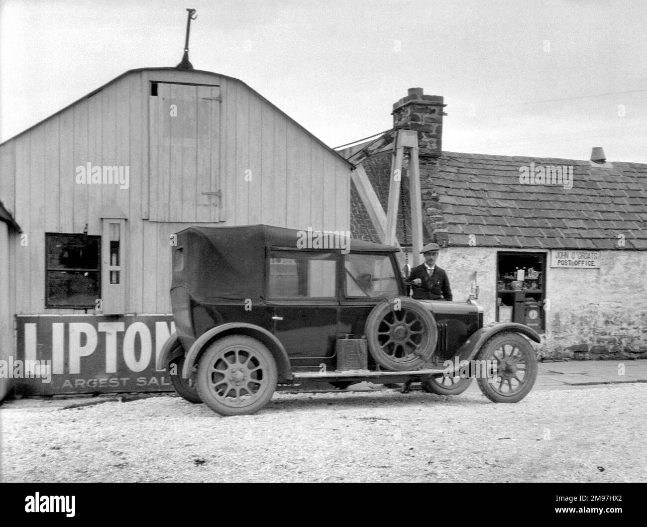 Man and car outside the Post Office, John o'Groats, Scotland. Stock Photo