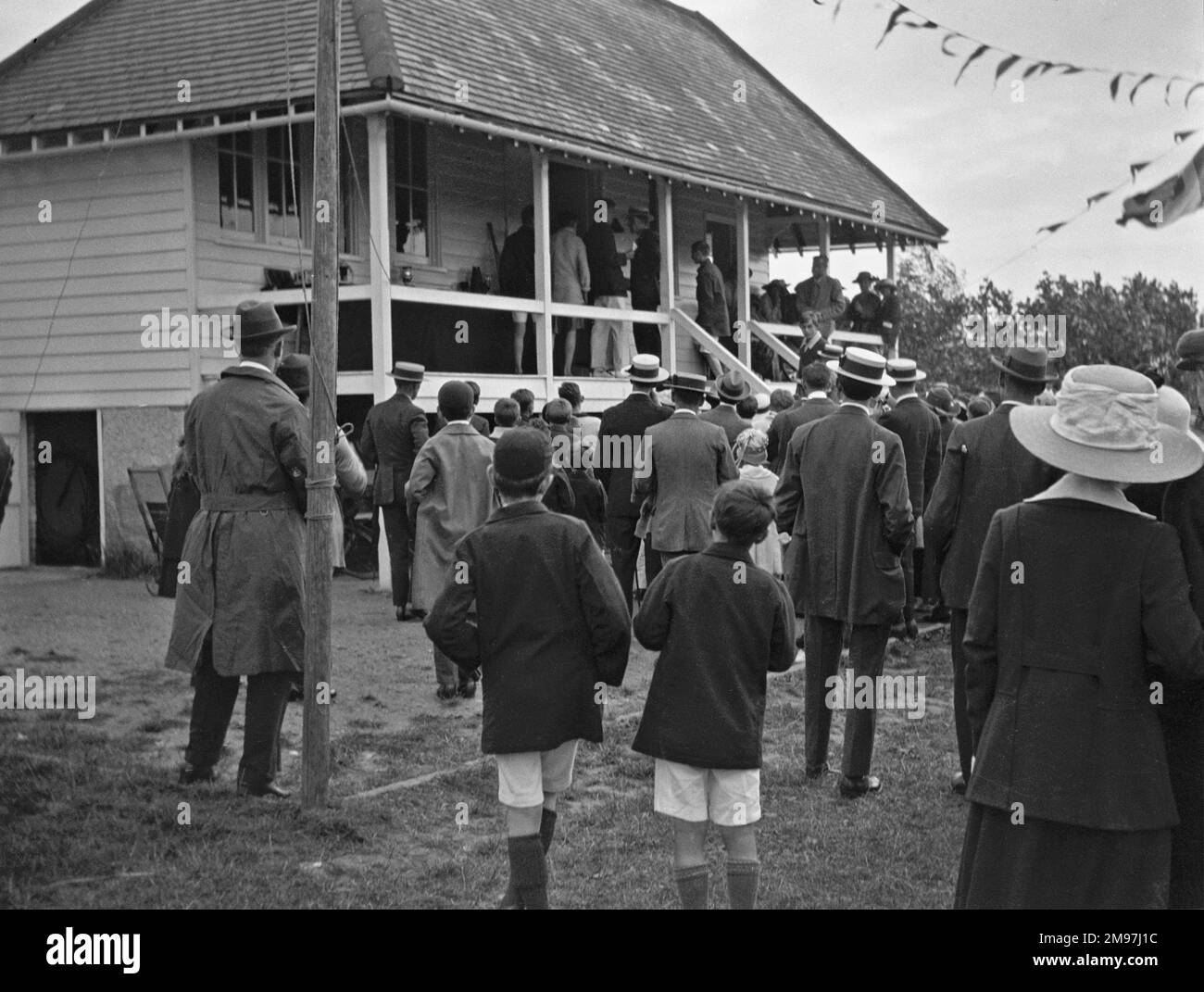 A crowd of people outside a sports pavilion. Stock Photo