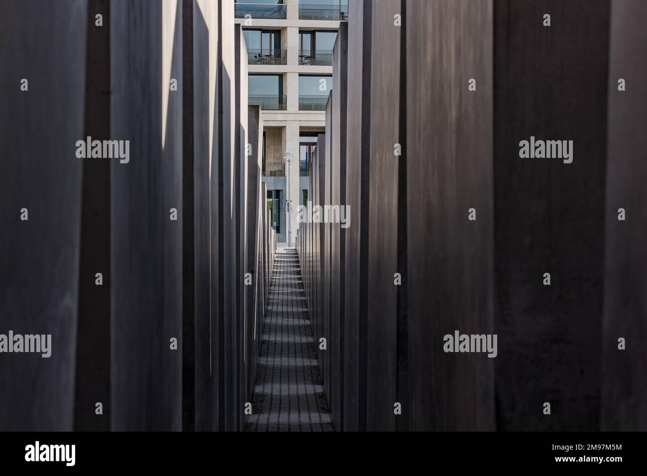 Between the depressing concrete blocks in the memorial for the Jewish victims of the Holocaust in World War 2, Berlin, Germany Stock Photo