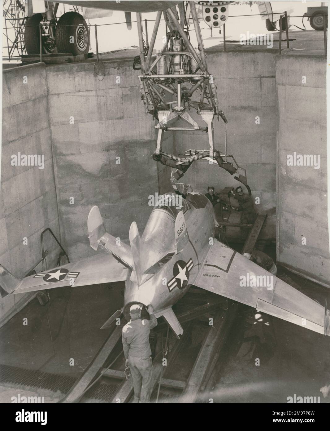 The first McDonnell XF-85 Goblin, 46-523, being attached to its trapeze underneath the mothership. Stock Photo