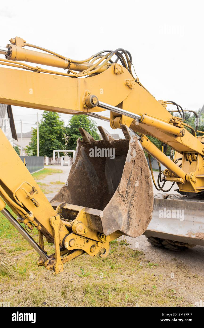 Hydraulic piston system excavator with a bucket. Construction work on