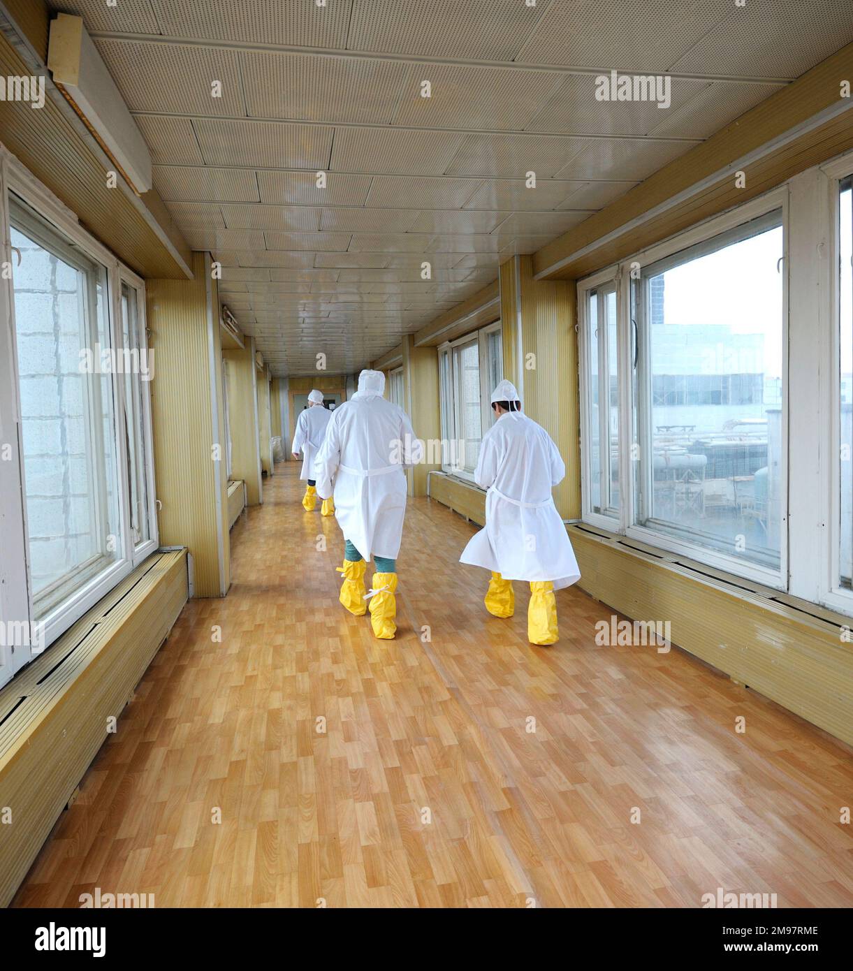 Workers in protective clothes going down the passageway of the