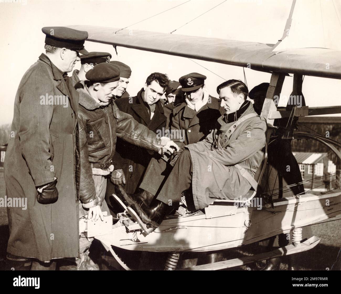 Flt Lt A.D. Piggott, Chief Instructor, with a class of schoolmasters explains the controls of a glider at Detling, near Maidstone, Kent. J.L. Smith, Chemistry Master, Dollar Academy, near Stirling, Scotland, is in the cockpit. January 1952. Stock Photo