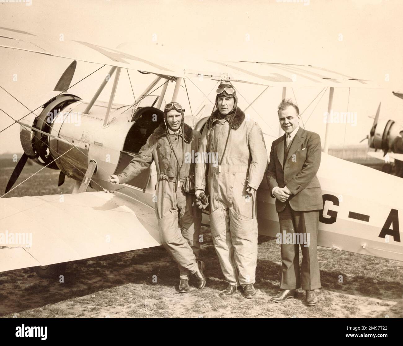 Lord Londonderry, then Secretary of State for Air, centre, takes delivery of his first aircraft at Heston Aerodrome, an Avro Club Cadet painted in Londonderry colours. Left is Capt Baker, Chief Instructor at Heston and B.S. Allen, right. March 1934. Stock Photo