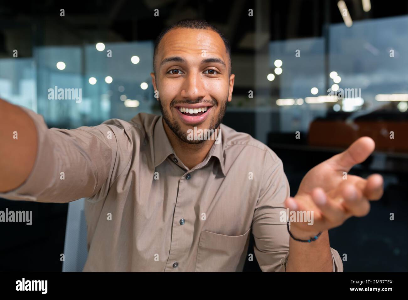 Video ringing, successful businessman looking at smartphone camera talking  remotely with colleagues, Hispanic man smiling at work inside office, webcam  view pov Stock Photo - Alamy