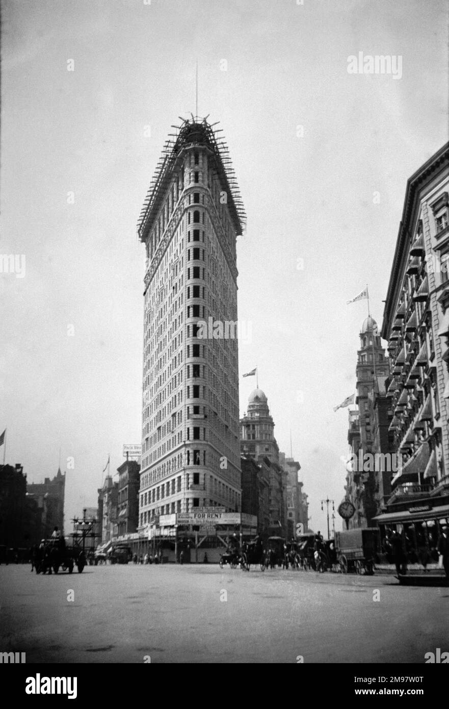 Flatiron building in its year of completion. Originaly named The Fuller building upon it completion in 1902. Now widely known as the Flatiron building due to its resemblance to a cast iron cloths iron. The building became a designated New York land mark in 1966, later in 1989 a national historic land mark. Stock Photo