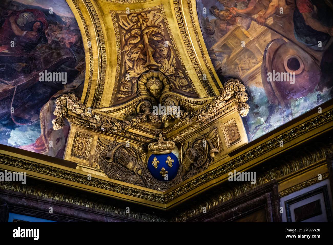 Paris, France - Dec. 28 2022: The highly decorative chandelier in Versaille Palace Stock Photo