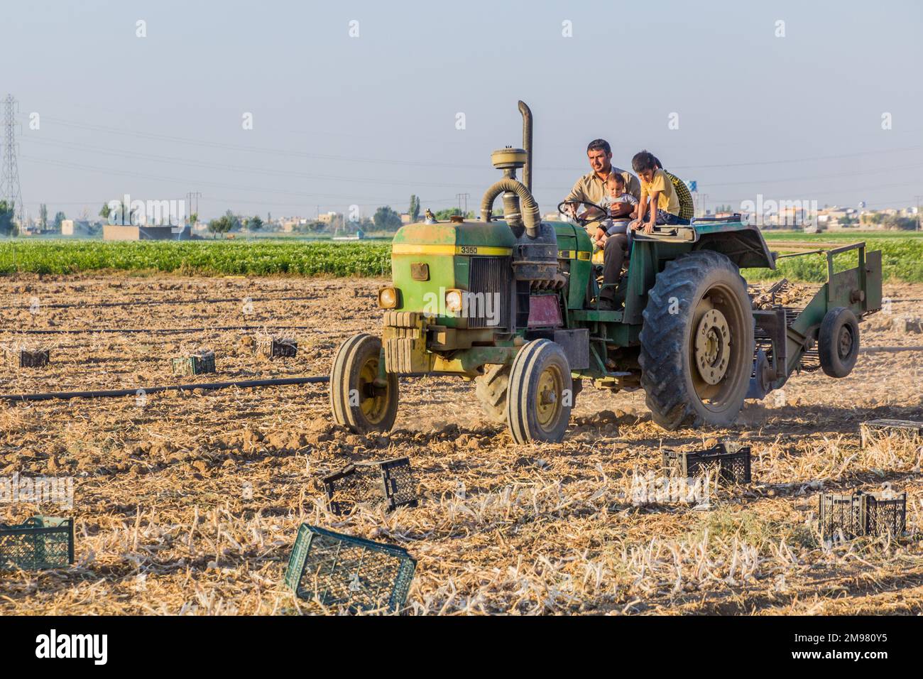 BAHAR, IRAN - JULY 13, 2019: Farmer family on their tractor near Bahar