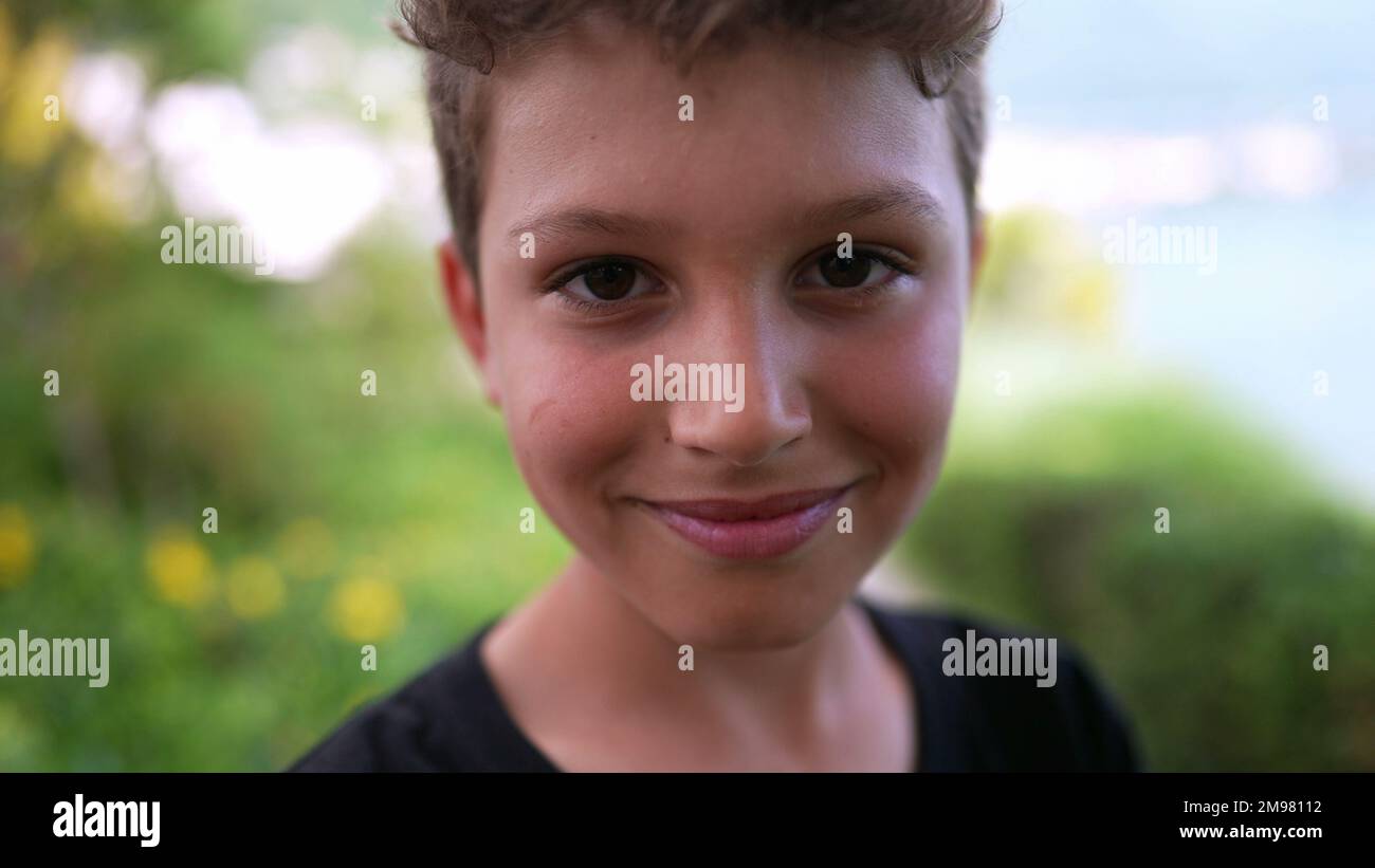 Handsome young boy portrait child smiling at camera outside Stock Photo ...