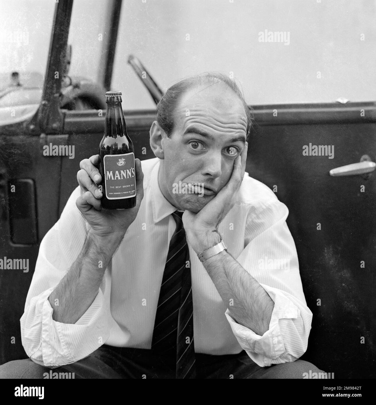 Advertisement for Manns brown ale male model holding up a bottle Stock Photo Alamy
