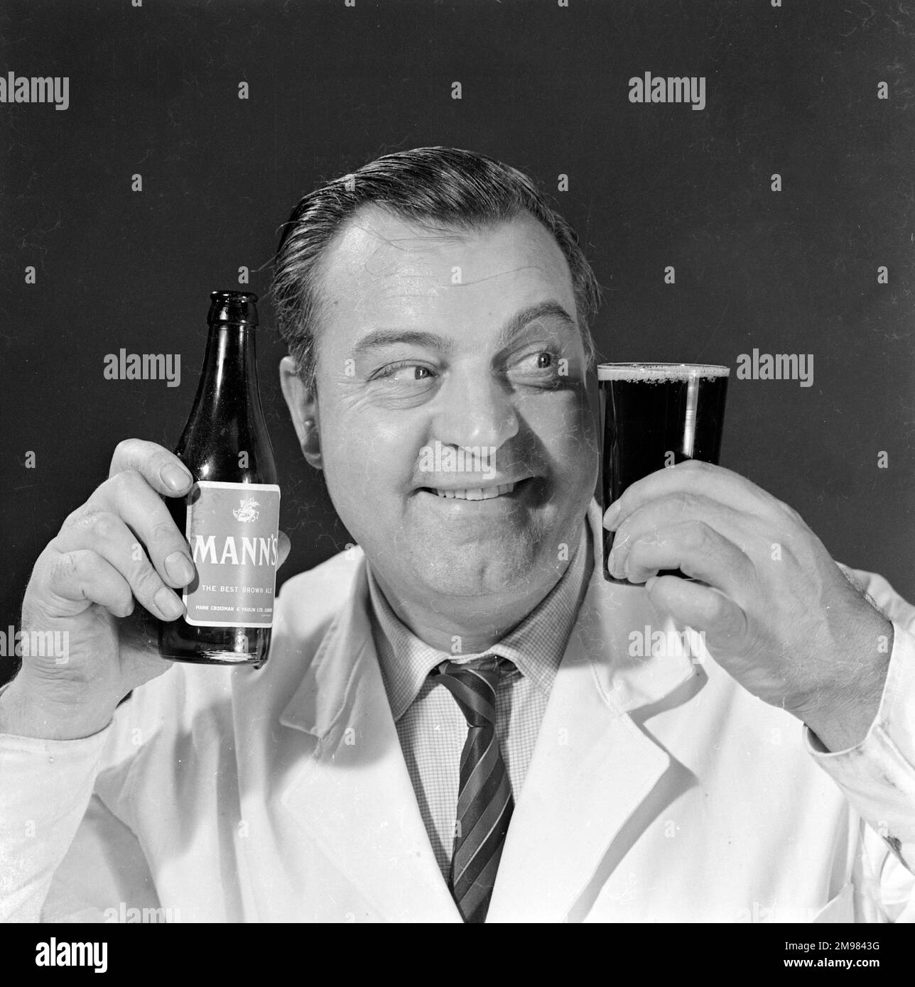 Advertisement for Manns brown ale male model holding up a bottle and a glass Stock Photo Alamy