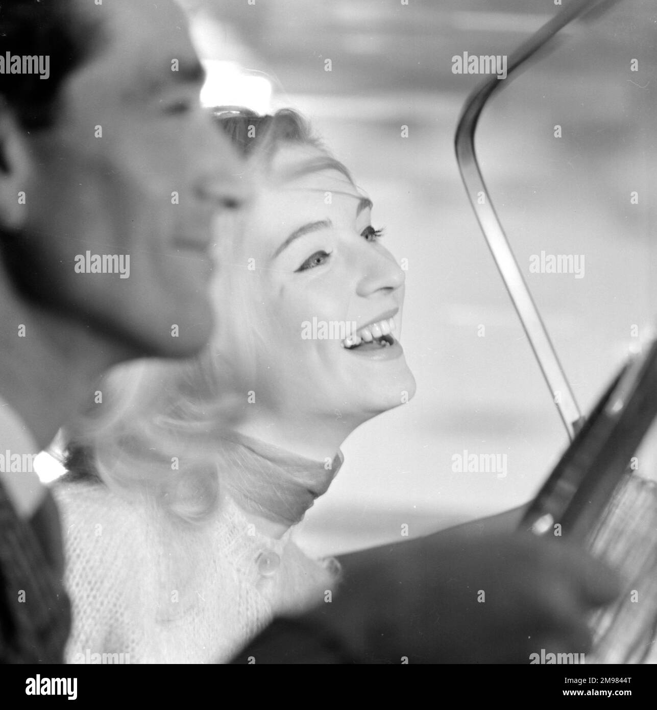 Advertisement for beauty products -- male and female models (D Orme and M Colbrook) posing in a car. Stock Photo