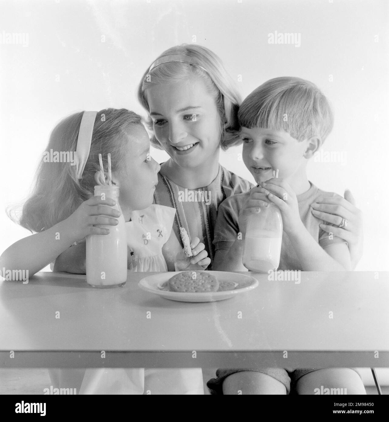 Advertisement for McVitie biscuits -- models posing as mother and two children (Jane Hancock, Merrill Colbrook and John Moulder Brown). Stock Photo