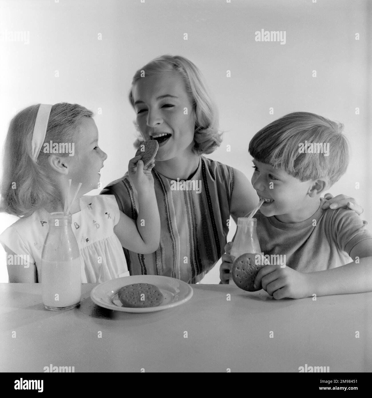 Advertisement for McVitie biscuits -- models posing as mother and two children (Jane Hancock, Merrill Colbrook and John Moulder Brown). Stock Photo