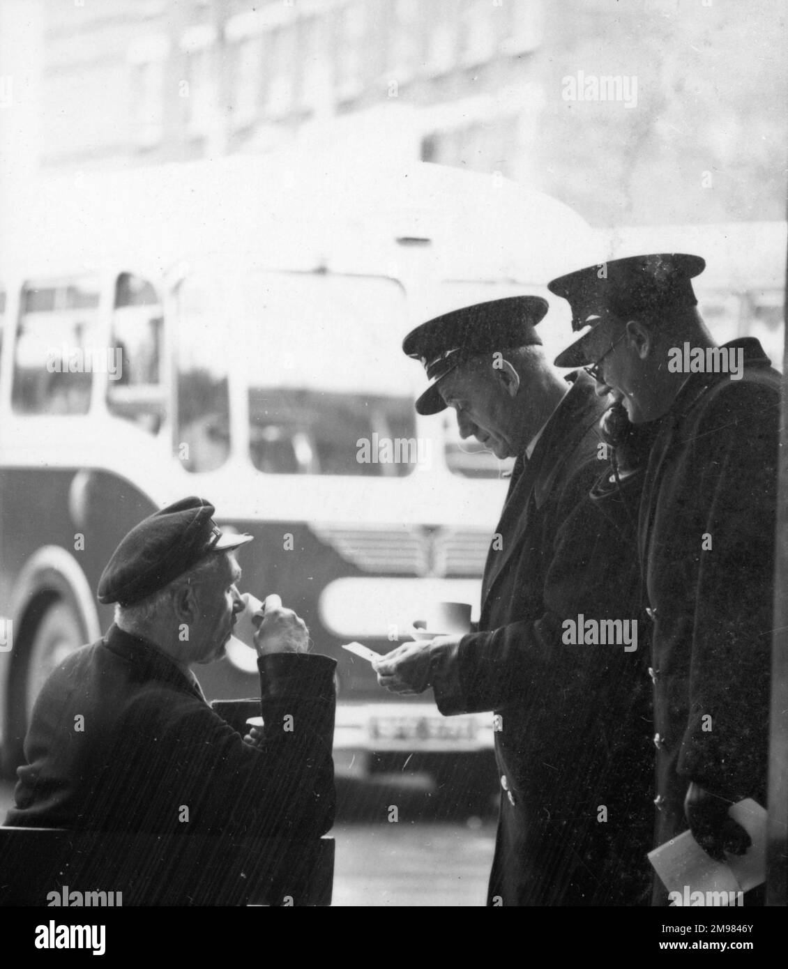 Advertisement for National Derv transport fuel -- group of bus conductors and drivers enjoying a tea break. Stock Photo