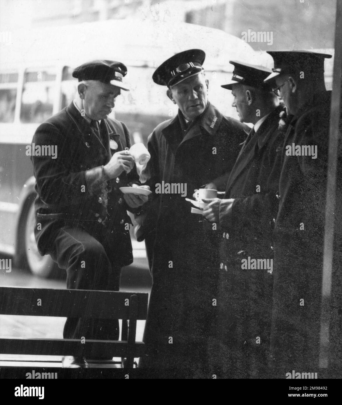Advertisement for National Derv transport fuel -- group of bus conductors and drivers enjoying a tea break. Stock Photo