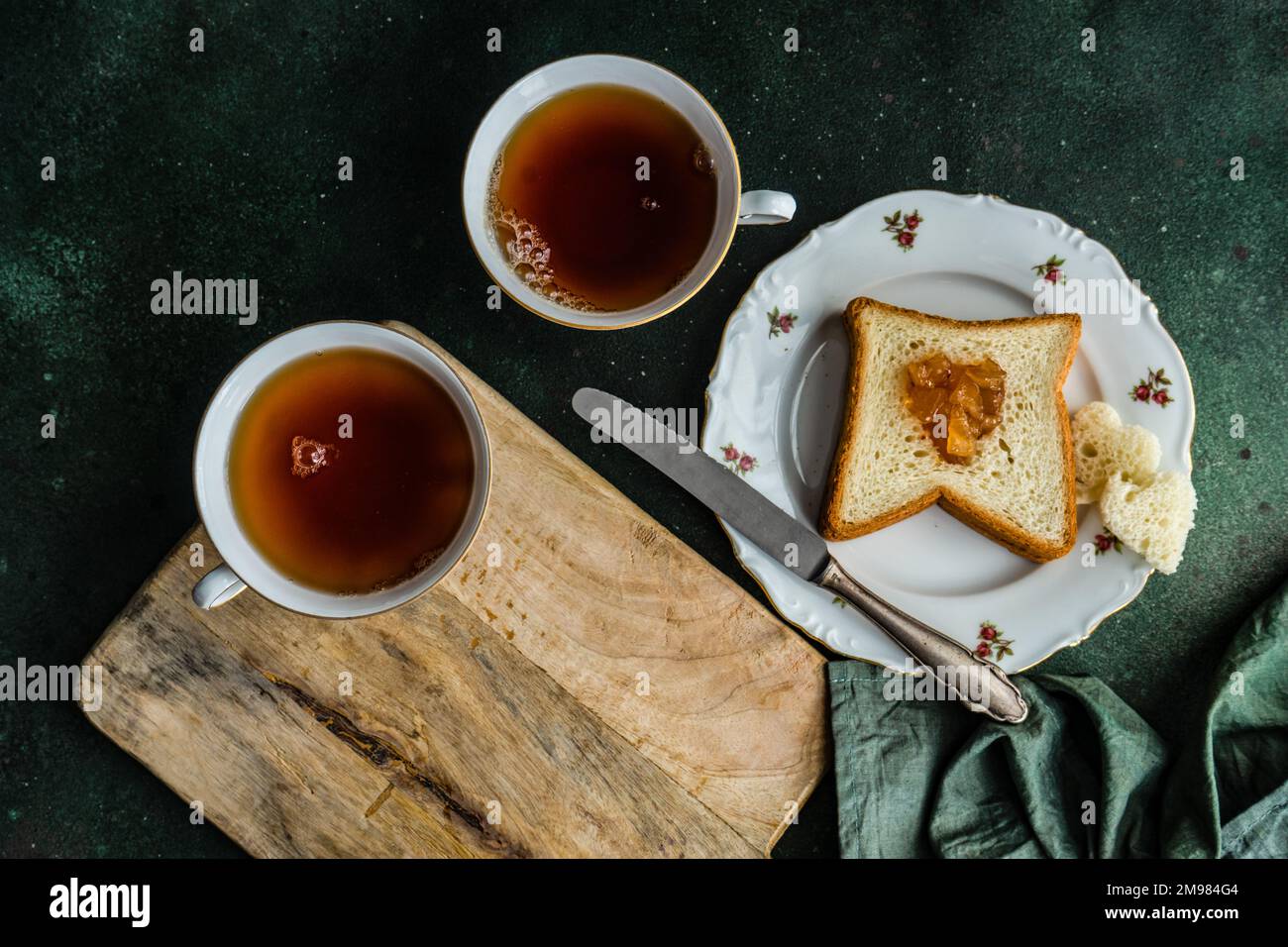 Overhead view of two cups of tea and a slice of toast with jam Stock Photo