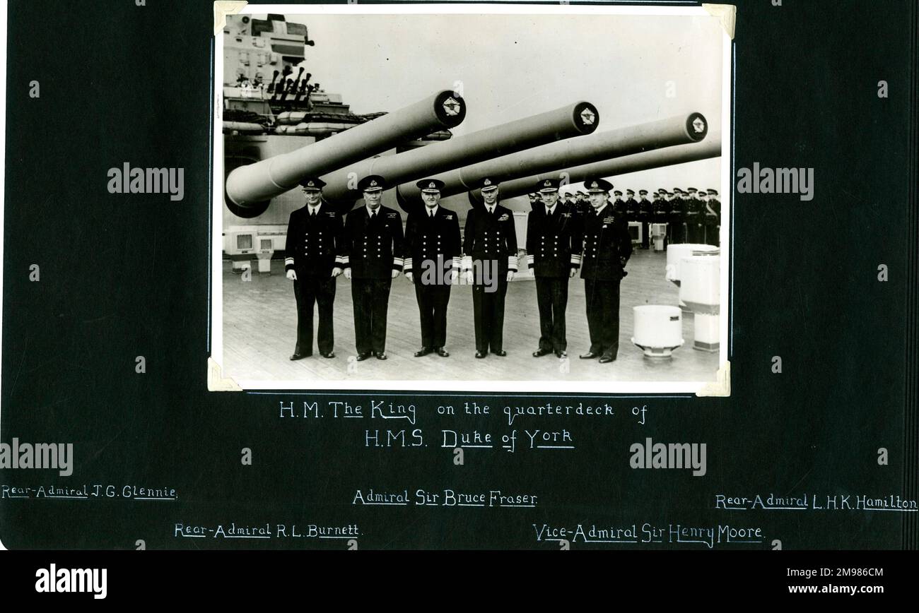 King George VI on the quarterdeck of HMS Duke of York, Scapa Flow, WW2.  With him are Rear-Admiral J G Glennie, Rear-Admiral R L Burnett, Admiral Sir Bruce Fraser, Vice-Admiral Sir Henry Moore, and Rear-Admiral L H K Hamilton. Stock Photo