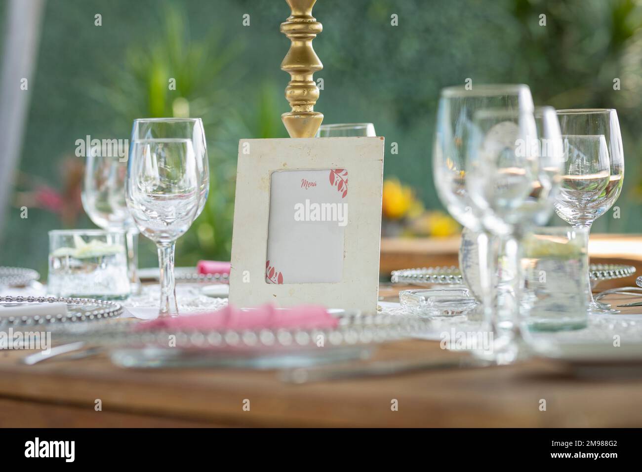 Elegant glassware on a table at a social event, in an outdoor garden Stock Photo