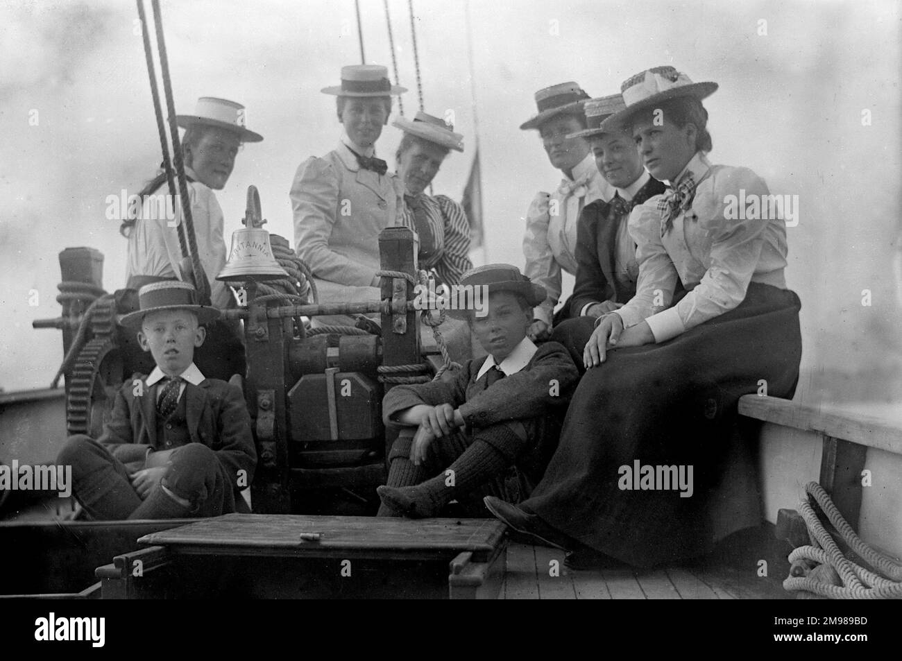 Group of women and boys on board a boat, the Cutter Britannia. Stock Photo