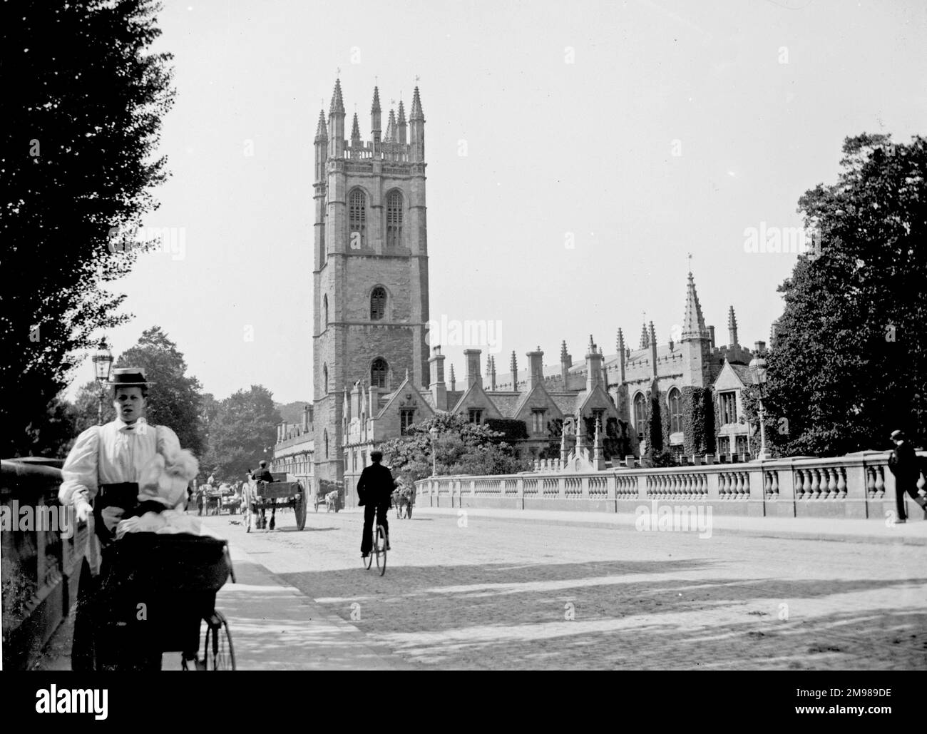 Street scene, Magdalen Tower and Bridge, Oxford, with traffic and pedestrians. Stock Photo