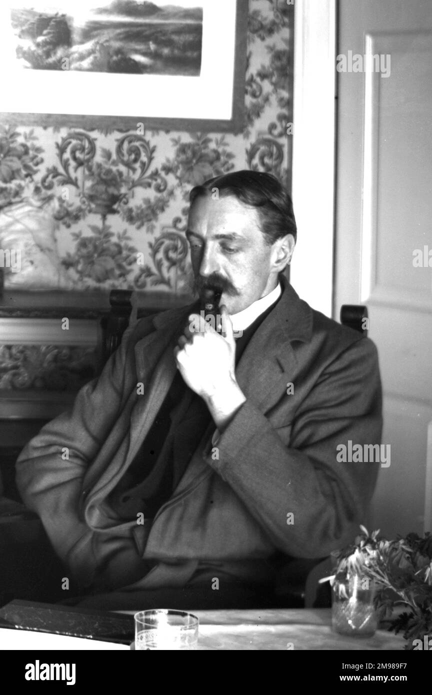 Seated pensive man smoking his pipe. Stock Photo