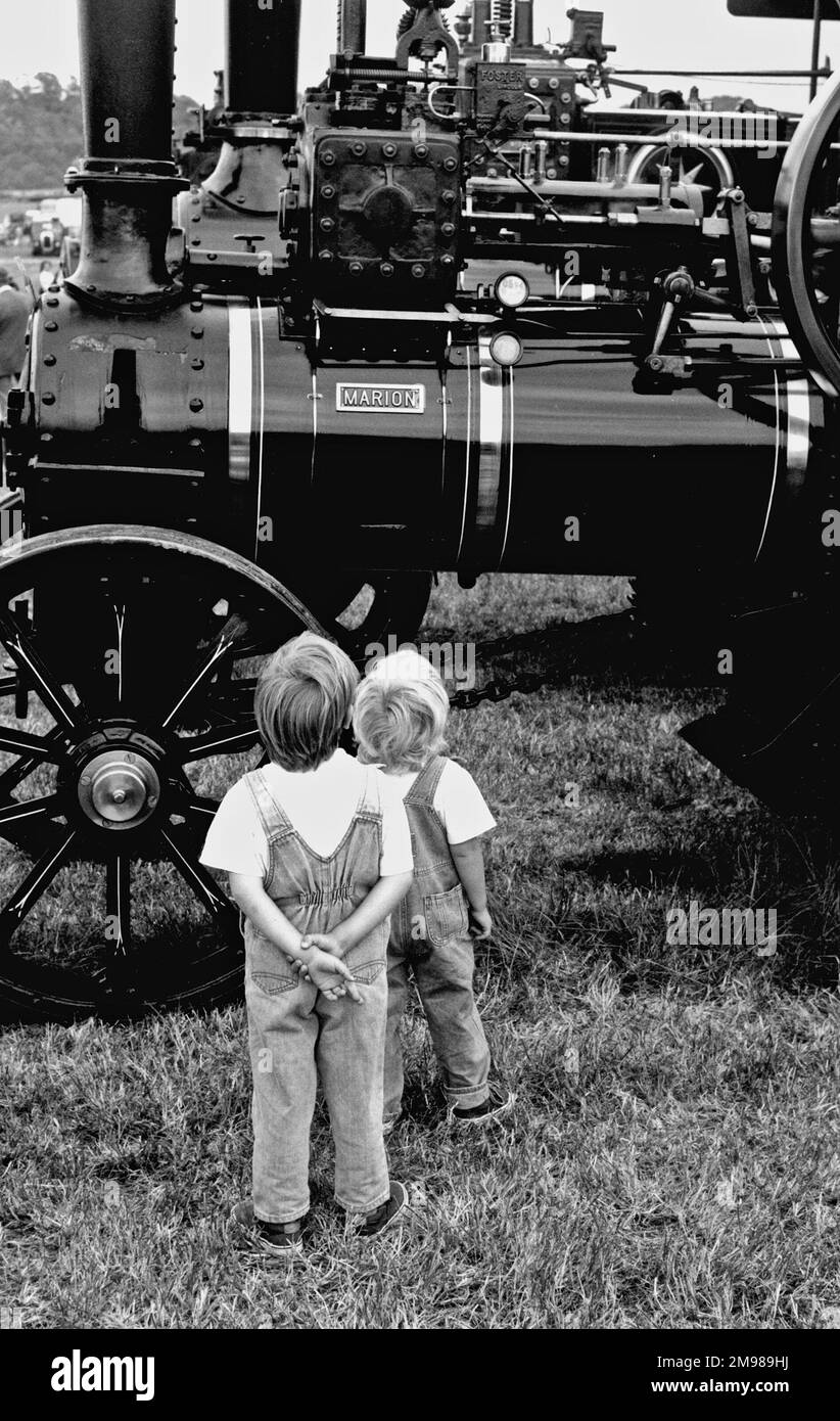 Two boys looking at steam engines at a festival in Hampshire, England. Stock Photo