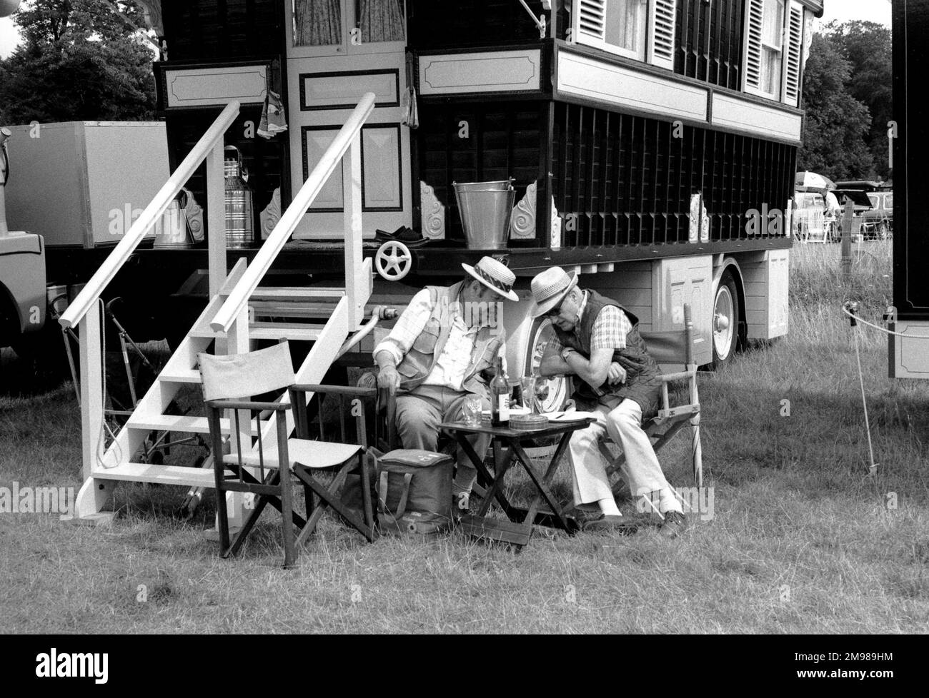 Two men sitting outside a traditional caravan Stock Photo - Alamy