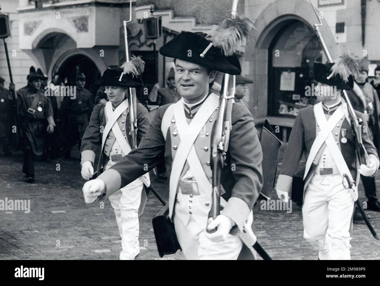 Men wearing historical military costume, marching through a street.in Lucerne, Switzerland. Stock Photo