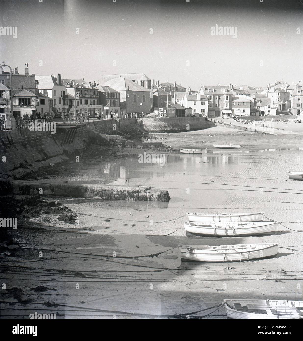 One of a great series of studies of St Ives, Cornwall. Wharf Road showing the bandstand, Crimson Tours, Harbour Cafe, Copper Kettle, Brig Y Don & Dinas Ia. Above the Slipway is John Park's house. Photograph taken from the West Pier. Stock Photo