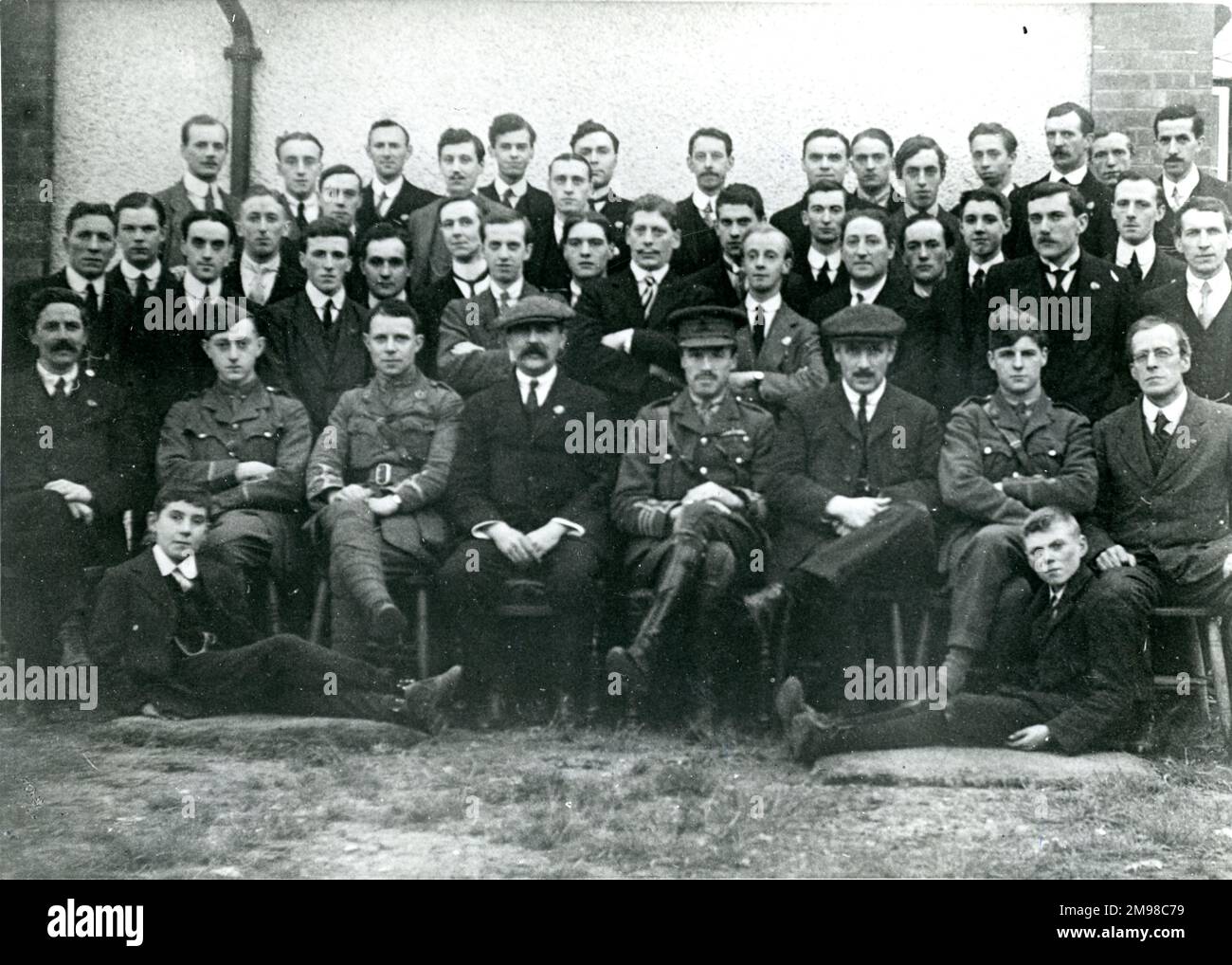 Headquarters staff of the AID Military Aeronautics Directorate outside the Officers? Mess at the Royal Aircraft Factory, Farnborough, in 1915. Seated in the front row, left to right: Prof H.P. Philpot, Maj G.P.Bulman, Dr A.P. Thurston, Capt Bagnall-Wild, Col Fulton, RA, Chief Inspector of Aeronautics; G.P. Cockburn, Maj F.B. Halford and Mr Ringwood. Stock Photo