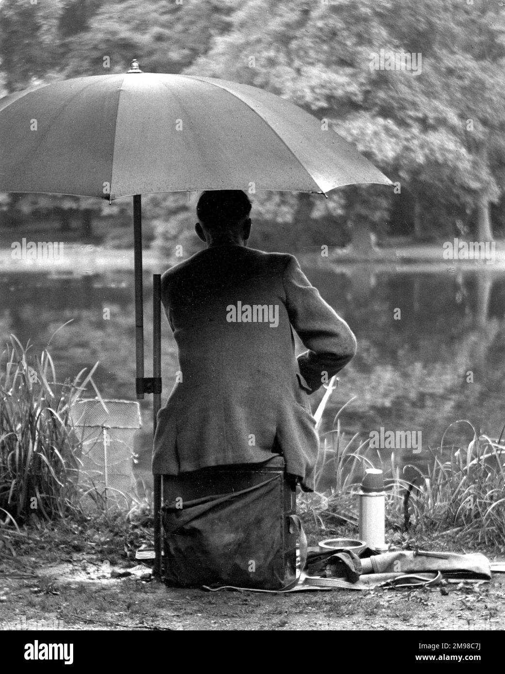 Fishing in the rain Wanstead Park, East London. Stock Photo