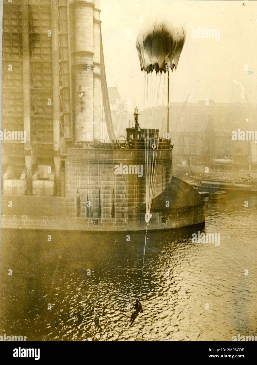 Lt Col Orde Lees about to hit the water after diving head first from Tower Bridge to demonstrate a Guardian Angel parachute, 11 November 1917. Stock Photo