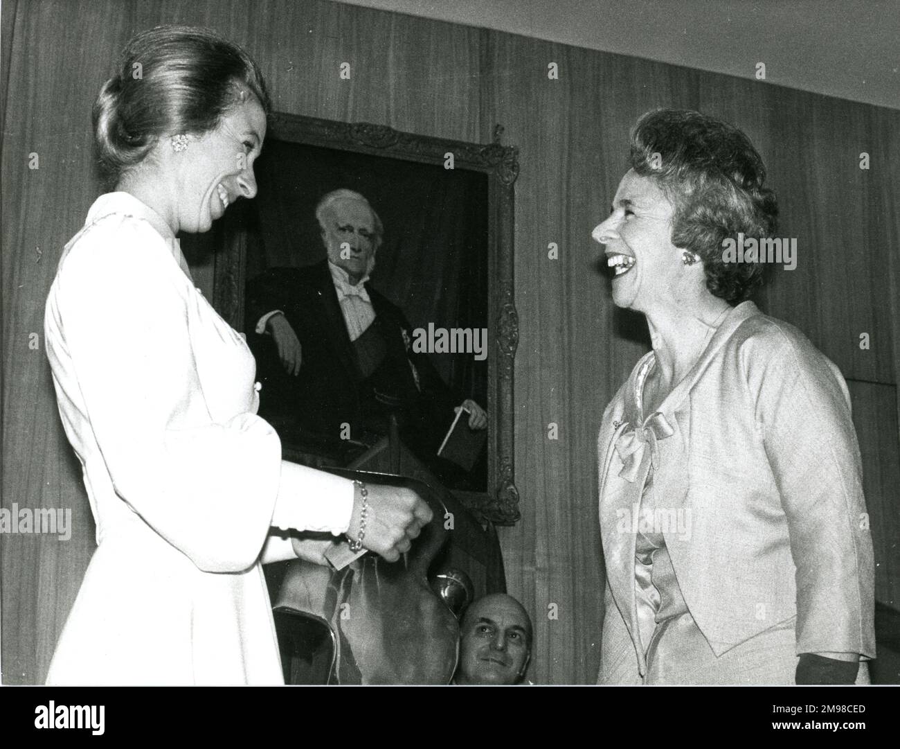 HRH The Princess Anne visited the headquarters of the Royal Aeronautical Society at No.4 Hamilton Place, London, on 20 May 1974 to present the Whitney Straight Award, a sculpture by Dame Barbara Hepworth, to Mrs Yvonne Sintes, right, in recognition of her contribution to civil aviation as an ATC Officer and commercial pilot. The Whitney Straight Award was donated in 1967 by Air Cdre Whitney Straight, Deputy Chairman of Rolls-Royce, to recognise the achievement and status of women in aviation. Stock Photo