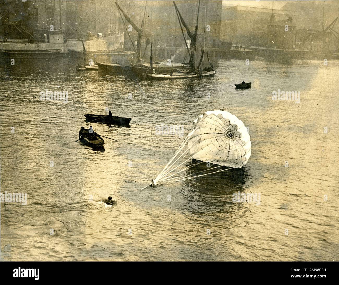 Lt Col Orde Lees being dragged through the water after diving head first from Tower Bridge to demonstrate a Guardian Angel parachute, 11 November 1917. Stock Photo