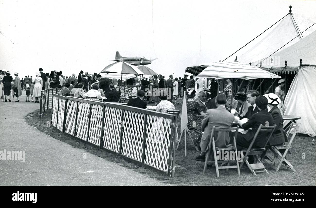 de Havilland Dove, G-ALVF, gives a low flypast at the 1956 Royal Aeronautical Society Garden Party at Wisley on 15 July. Stock Photo