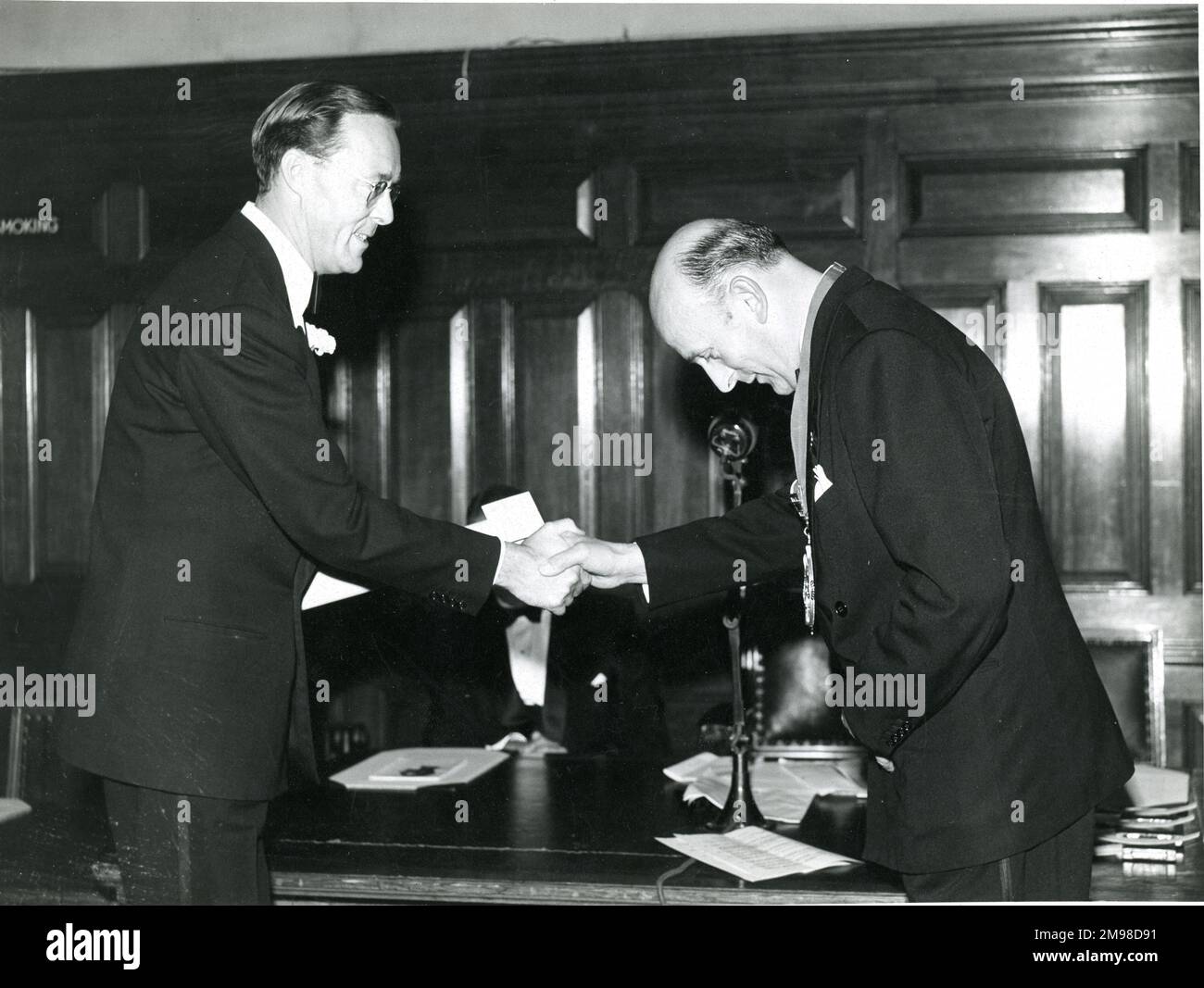 HRH Prince Bernhard of The Netherlands, left, is presented with his certificate of Honorary Fellowship by Sir George Edwards, President of the Royal Aeronautical 1957-1958, prior to the 45th Wilbur Wright Lecture on 13 September 1957 at the Institution of Civil Engineers, Great George Street, London. Stock Photo