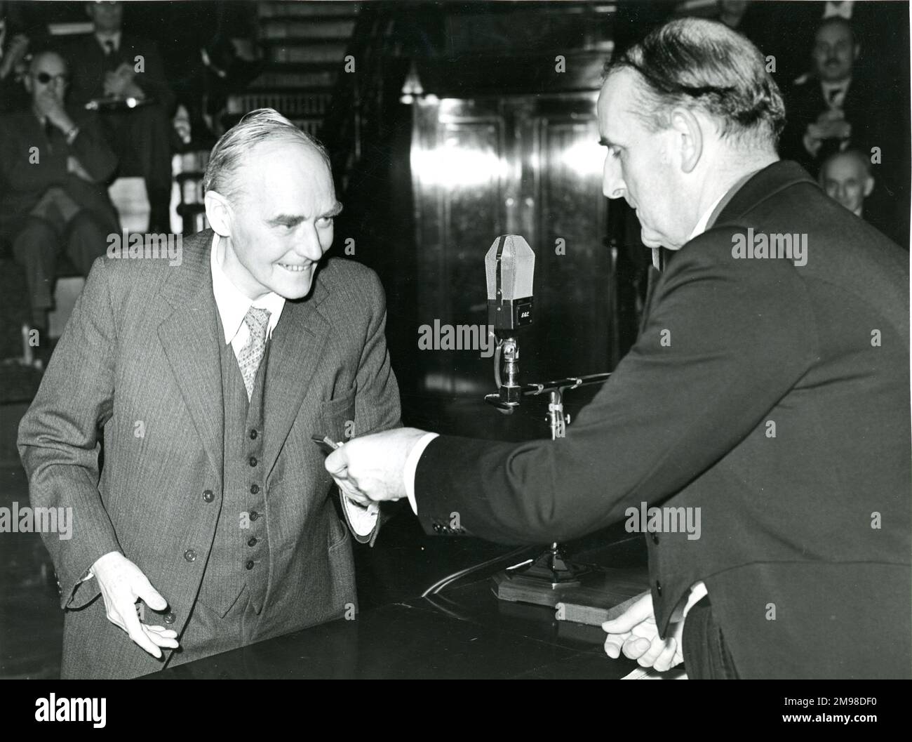 Sir Sydney Camm, CBE, FRAeS, 1893-1966, RAeS President 1954-1955, right, presents Sir Geoffrey Taylor with the Royal Aeronautical Society Gold Medal prior to the 42nd Wilbur Wright Lecture on 20 May 1954 at the Royal Institution, 21 Albemarle Street, London. Stock Photo