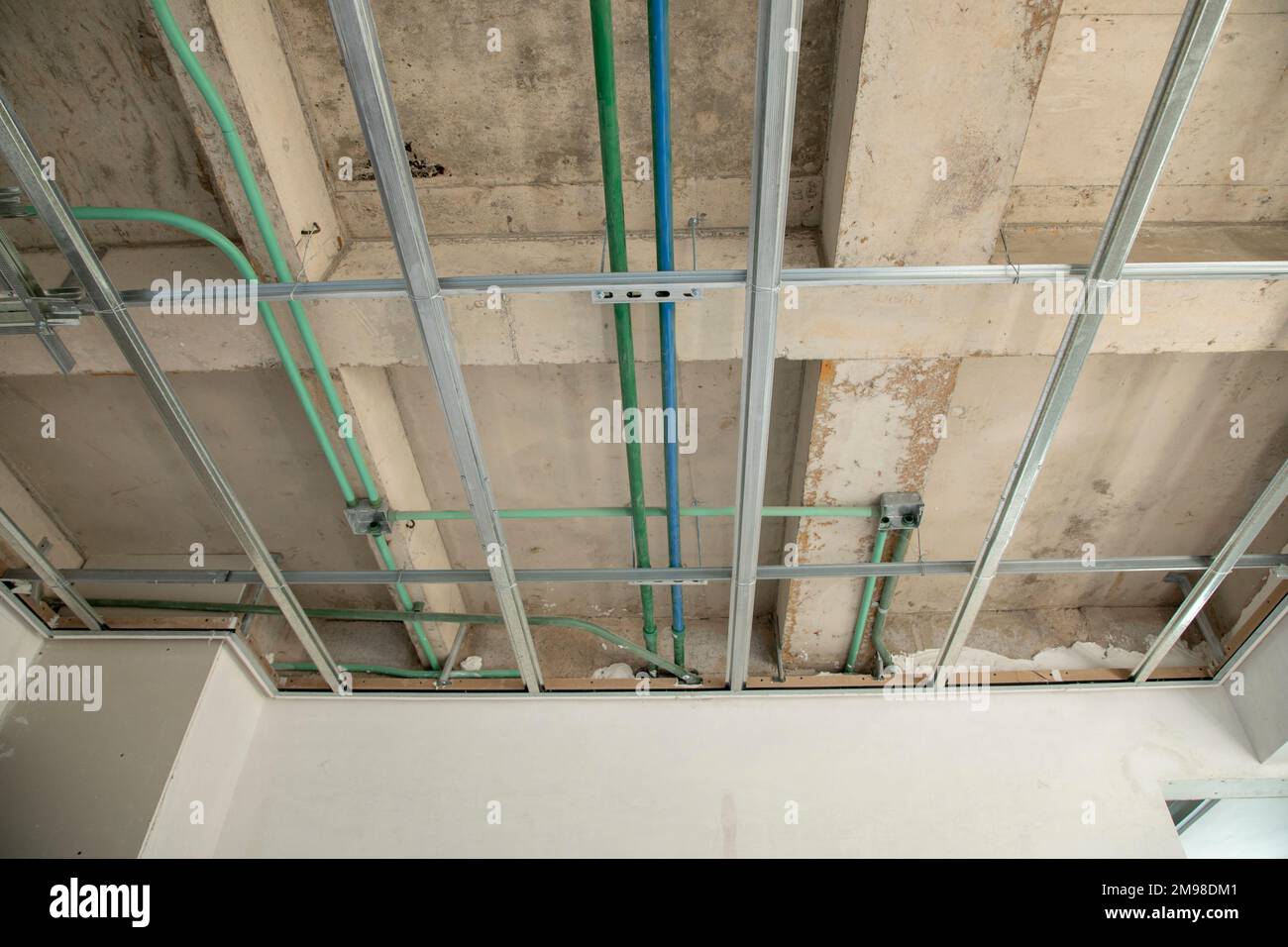 Piping and electrical installations in construction ceiling Stock Photo