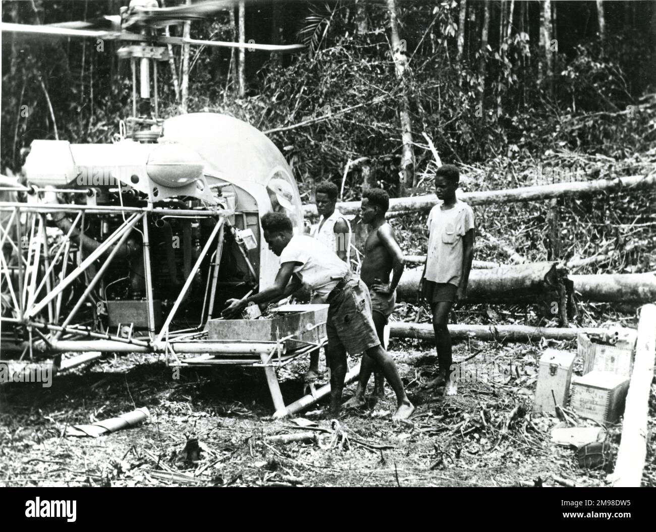 Bell Model 47D being used to aid the search for oil in Western New Guinea in 1953. Stock Photo