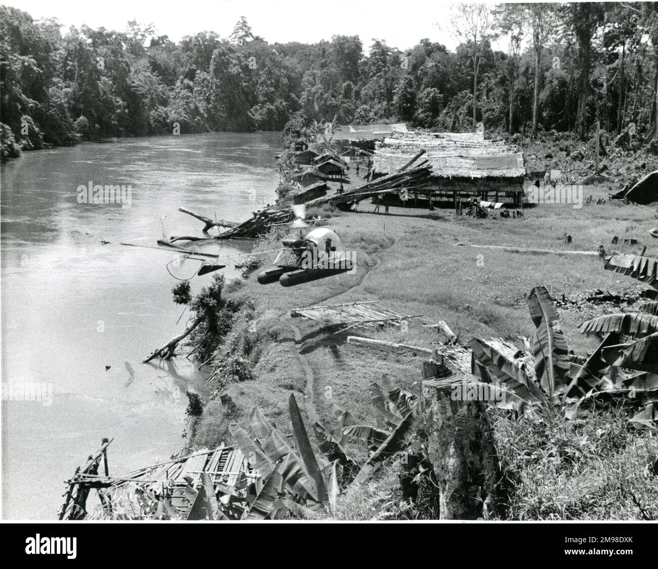 Bell Model 47 being used to aid the search for oil in Papua in 1954 lands near Seismic One Camp. Stock Photo