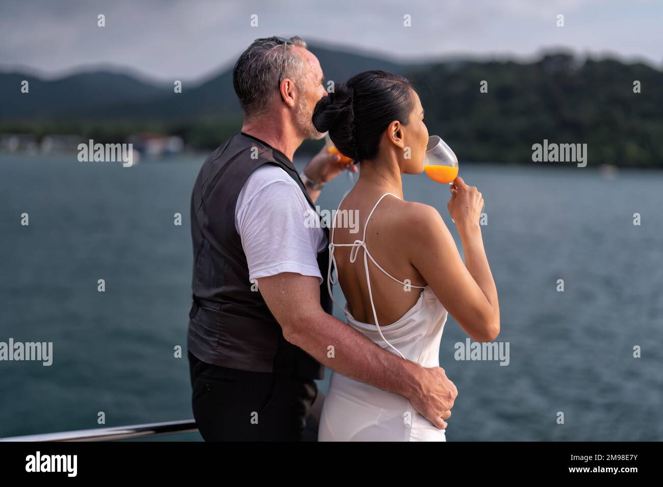 Romantic couple in love have fun sailing in the sea standing on yacht deck enjoy amazing view Stock Photo