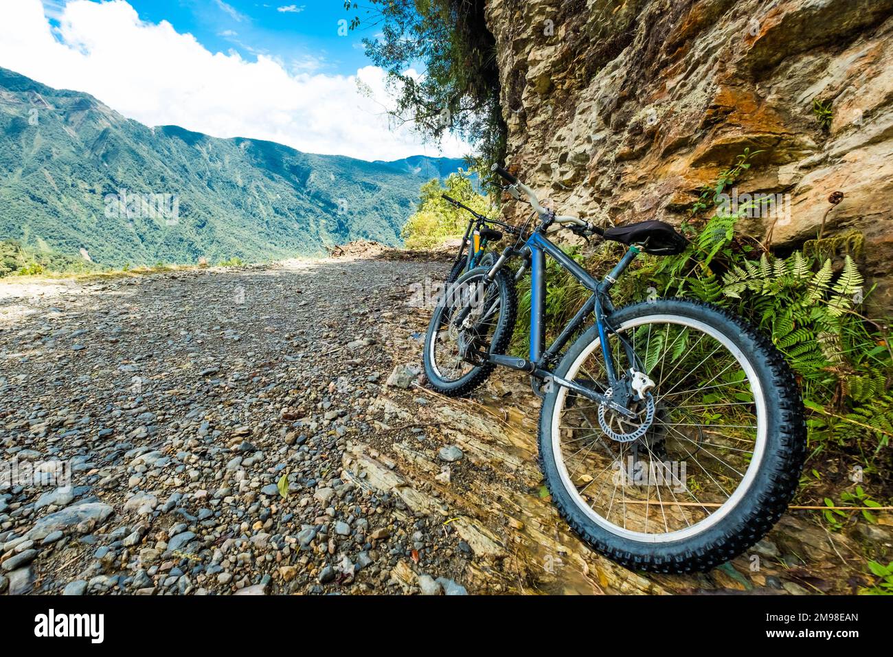 Black mountain bikes by the rock Stock Photo Alamy
